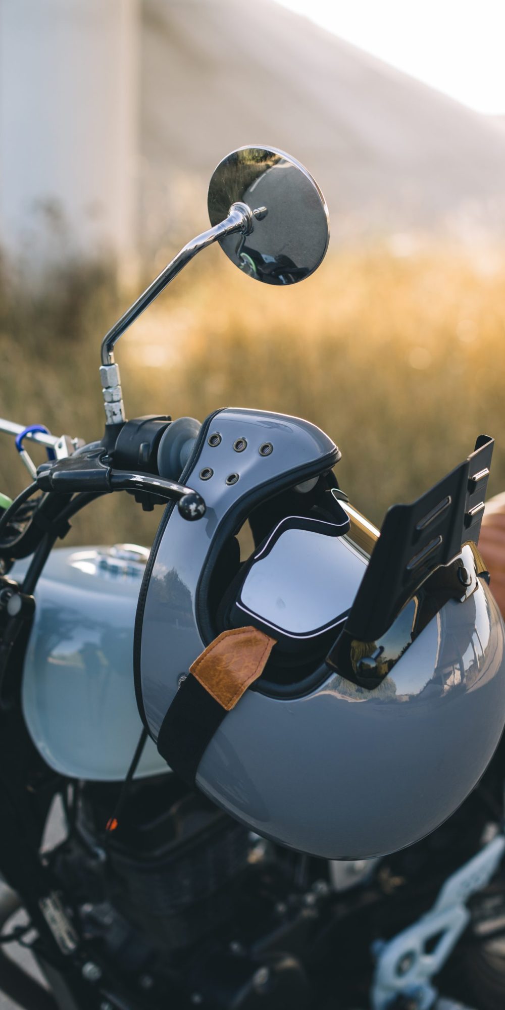 motorcycle white helmet with goggle hanged in a handle bar motorcycle white helmet with goggle hanged in a handle bar